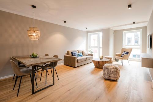 a living room with a table and a couch at Apartments by Altes Zollamt in Husum