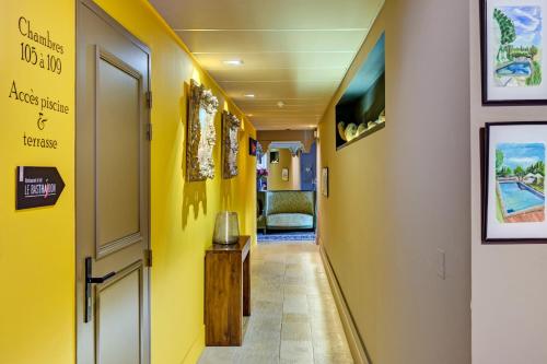 a hallway with yellow walls and a hallway with a yellow wall at Hotel Bastide & SPA - Villa de Lourmarin in Lourmarin