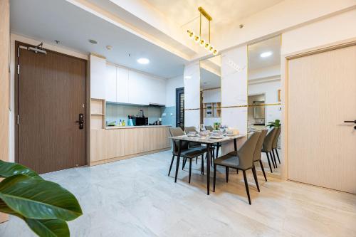 a dining room and kitchen with a table and chairs at Cardinal Court Phu My Hung near SECC & Crescent in Ho Chi Minh City