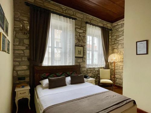 Postel nebo postele na pokoji v ubytování Urla Taş Konak Otel