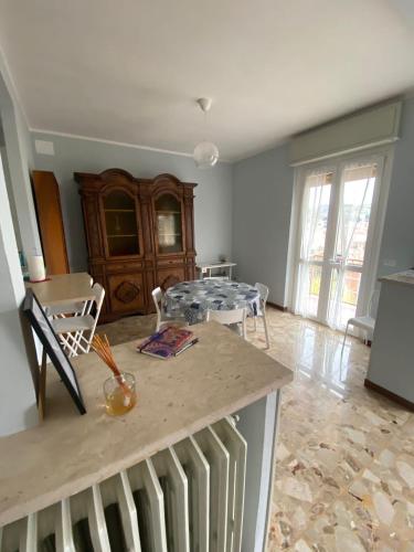 a kitchen and living room with a table and chairs at Bella Vista in Canelli