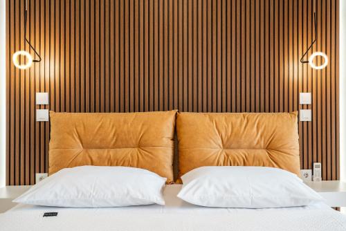 two pillows on a bed in a room with a wall at Eldorado Luxury Villa in Afantou