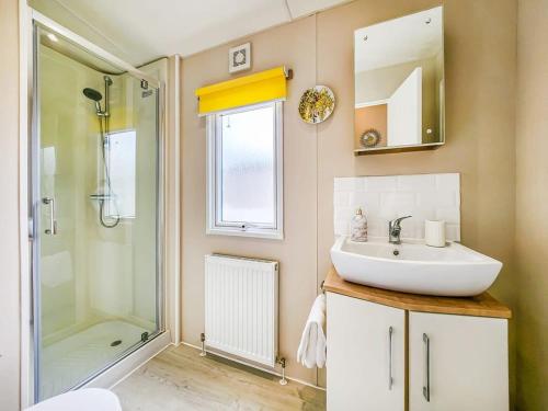 a bathroom with a sink and a shower at Escape to Paradise at Pevensey Bay Holiday Park 13 Woodland Walk in Pevensey