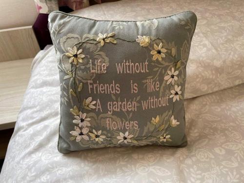 a pillow on a bed with a flower design on it at 49 Bayside Cove Pevensey Bay Holiday Park in Pevensey