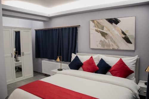 a bedroom with a bed with red and blue pillows at Guest Rooms Diamant Biel/Bienne in Biel