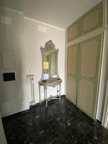 a room with a mirror on a table next to a door at Bella Vista in Canelli