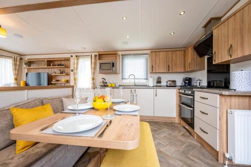 a kitchen with a table with two plates on it at Your Ultimate Holiday Rental at Pevensey Bay 35 Woodland Walk in Pevensey