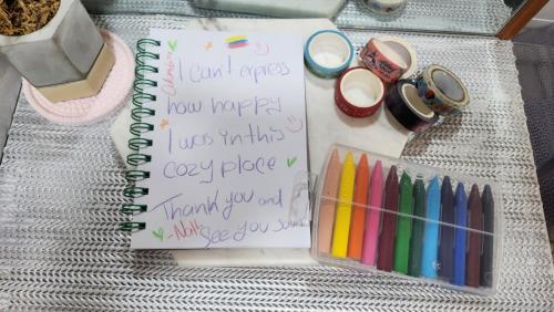 a notebook with writing on it next to pens and pencils at Serein_HongDae in Seoul