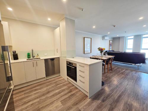 a kitchen and dining room with a table in a room at Spacious & Luxurious Newtown Central in Wellington