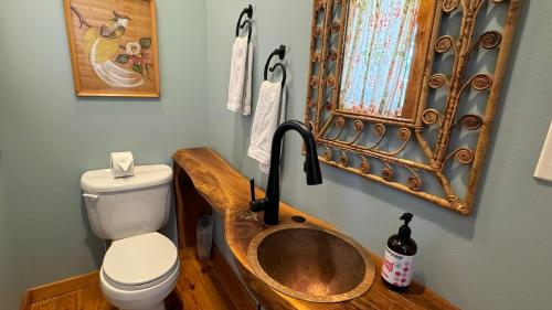 a bathroom with a wooden sink and a toilet at Victory Gardens in Union Pier