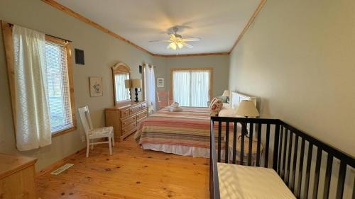 a bedroom with a bed and a ceiling fan at Victory Gardens in Union Pier