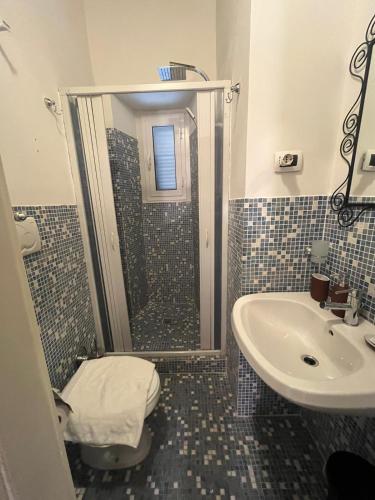 a bathroom with a shower and a toilet and a sink at Sweet House Campo de’ Fiori in Rome