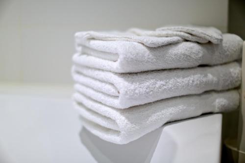 a stack of white towels sitting on top of a table at Royal Apartments Brussels in Brussels