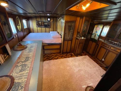 Cette petite chambre comprend un lit et un tapis. dans l'établissement Dépaysement Art déco sur Seine à 2 pas de Paris, à Saint-Cloud