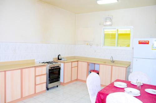 a kitchen with a table and a stove top oven at درة 1 in Al Jubail