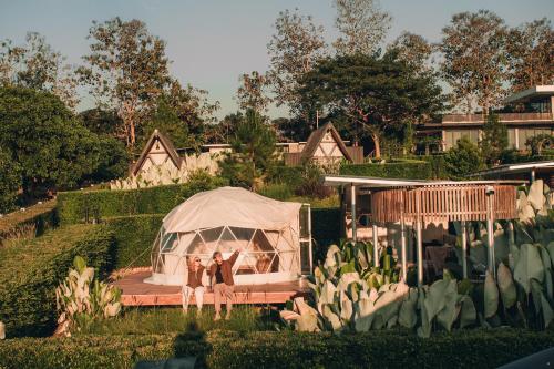 a group of three people standing in front of a tent at The CAMPIAN in Chiang Mai