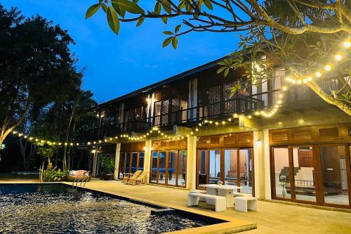 a house with a swimming pool and lights at SS pool villa hills in Ban Tao Than