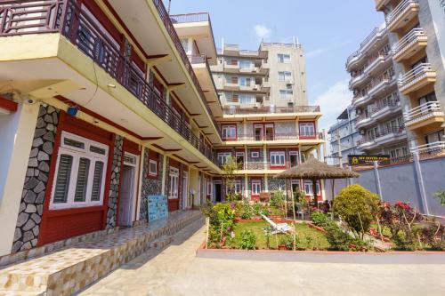 a building with a garden in front of it at Hotel Angel in Pokhara