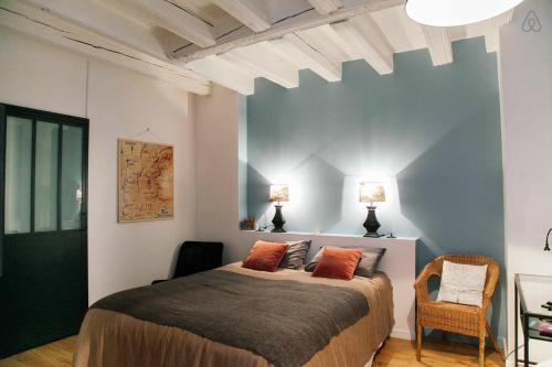 a bedroom with a large bed with two pillows at Saint-Paul Vieux Lyon - parking included in Lyon