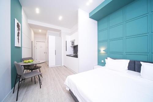 a bedroom with a bed and a table with a chair at Sweet Home Apart-Hotel in Yerevan