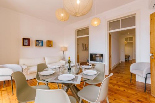 a living room with a table and chairs and a couch at RENT4REST CASTLE VIEW FAMILY & FRIENDS Bairro Alto in Lisbon