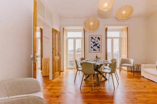 a living room with a table and chairs at RENT4REST CASTLE VIEW FAMILY & FRIENDS Bairro Alto in Lisbon