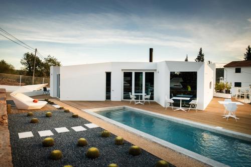 a house with a swimming pool in the backyard at Boutique Hotel - Casa Esteval in Rocha Amarela