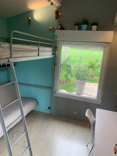 a room with bunk beds and a window at Sur les Routes du Débarquement - Chambre Quadruple - in Bavent