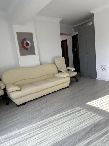 a living room with a couch and a chair at Cozy Holidays in Center of Suceava Esplanada in Suceava