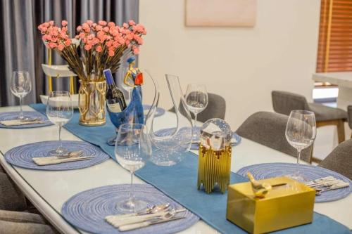 a table with wine glasses and flowers on it at 2 BRs villa with private pool ( Villa 2 PN hồ bơi riêng) in Dien Khanh