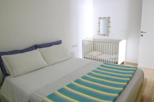 a bedroom with a bed with a crib in it at Villa Sun in Golem