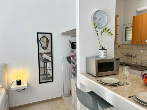 a kitchen with a counter with a microwave on it at Marvel City Studio in the centre in Rethymno Town