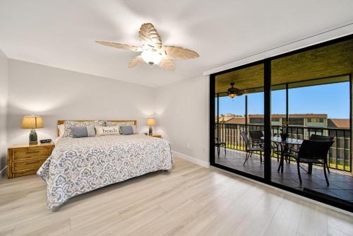 a bedroom with a bed and a ceiling fan at Loggerhead Cay #434 in Sanibel