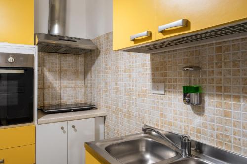 a kitchen with a sink and a counter top at Villa Gaudì - Batllò in Sant'Isidoro