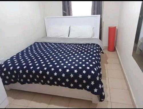 A bed or beds in a room at Amazing 1 Bedroom Apartment, Juja