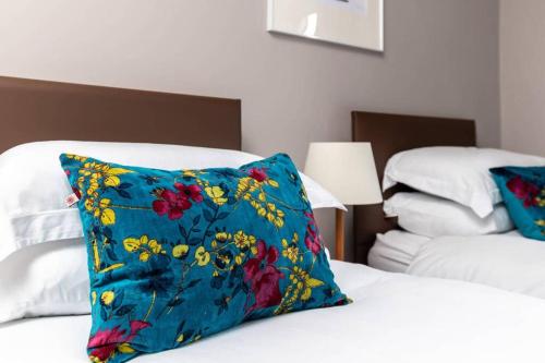 a blue pillow sitting on top of a bed at 6 Howard Place in St. Andrews