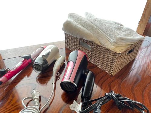 a wooden table with a basket and some microphones at 農家古民家ねこざえもん奥屋敷 Nekozaemon-Gest house in Nishiwada
