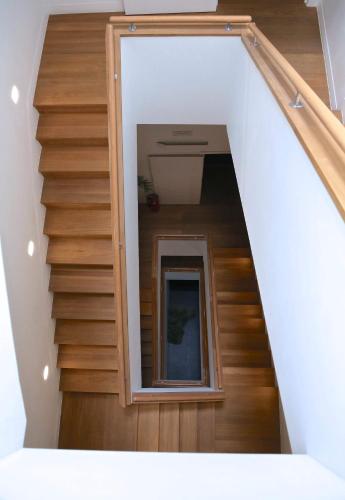 a staircase with a mirror in the middle of a room at Royal Apartments Brussels in Brussels