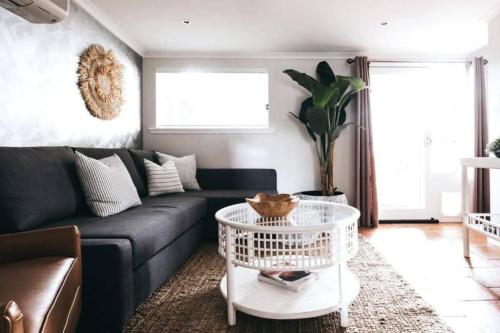 a living room with a couch and a table at The Icely Cottage in Orange