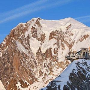 a snow covered mountain with a truck parked on it at MAISON DU BOURG in Courmayeur