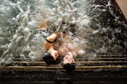 a woman laying in the water on some stairs at Hotel Steffisalp in Warth am Arlberg
