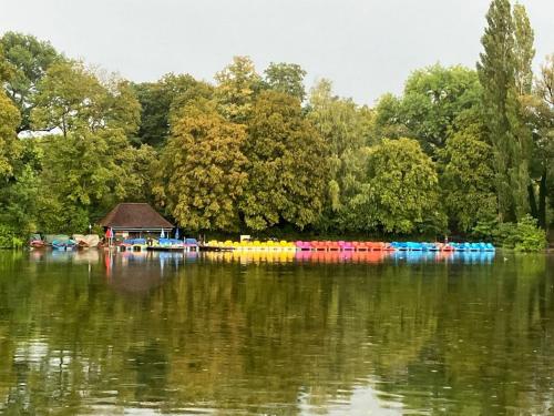 a lake with a group of boats in the water at Hotel Occam in Munich
