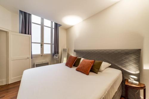 1 dormitorio con 1 cama blanca grande y 2 almohadas en Haven of peace in the heart of Lyon, en Lyon