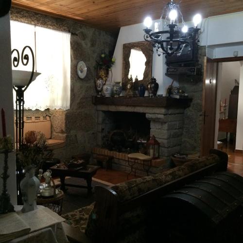 a living room with a couch and a fireplace at Quinta Formosa in Vale Formoso