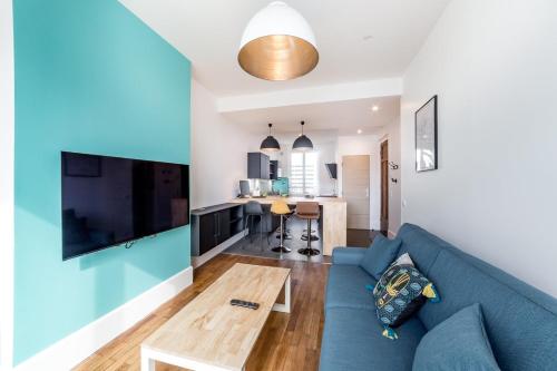 a living room with a blue couch and a table at Brand new apartment 2022 Lyon Part-Dieu AIL in Lyon