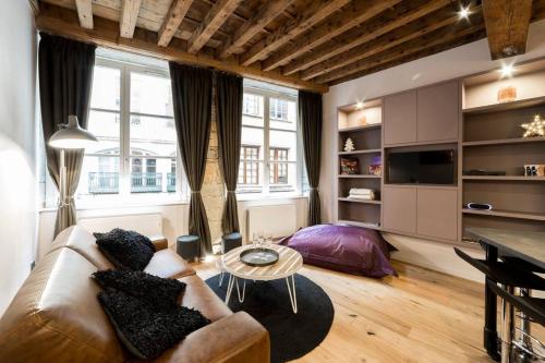 a living room with a couch and a table at Jewel apartment in Vieux Lyon AIL in Lyon