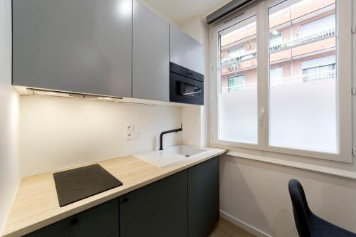 une cuisine avec un évier et une fenêtre dans l'établissement Studio - proche métro AIL, à Lyon