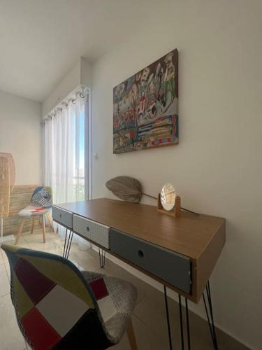 un salon avec un bureau et une chaise dans l'établissement Superbe Appartement Vue Mer T3 70m2, à Mauguio