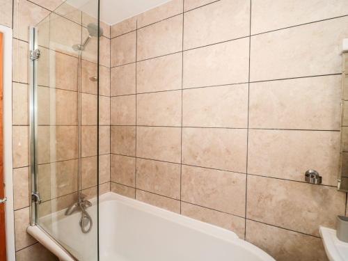 a bathroom with a shower and a bath tub at Garland in Weymouth