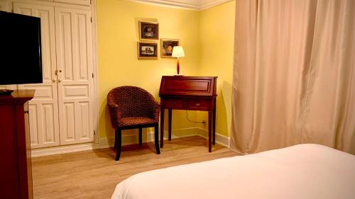 a bedroom with a desk and a chair and a bed at Marina de Campios in Comillas